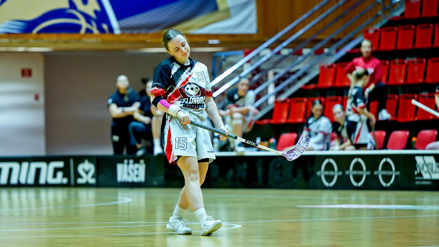 Floorball player in a custom white and red jersey during a match