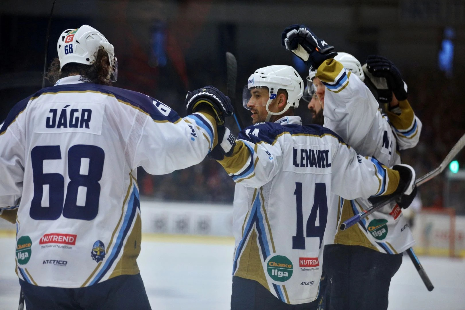 Hockey players in custom white and navy EURO SPORTIVO jerseys celebrating on the ice